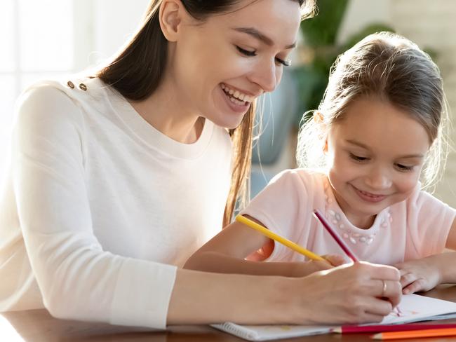 CHILDCARE/ CHILD/ YOUNG/ YOUTH -  Overjoyed young Caucasian mother and little 7s daughter have fun drawing in album on family weekend together. Happy mom and small girl child engaged in funny activity paining. Hobby concept.