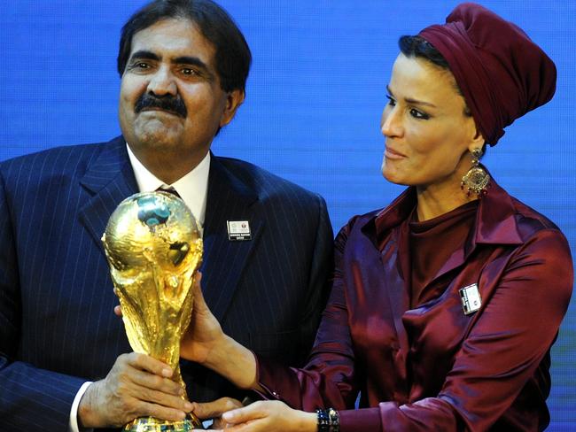 Sheikh Hamad bin Khalifa Al-Thani, Emir of Qatar, left, and Sheika Mozah bint Nasser al-Misned hold the World Cup trophy after the announcement of Qatar hosting the 2022 soccer World Cup in Zurich, Switzerland, Thursday, Dec. 2, 2010. (AP Photo/Keystone, Walter Bieri)
