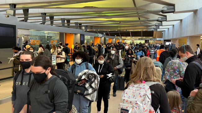 The pandemic is like a doorway. Once you pass through, there is no going back. Above, holiday travellers transit through Dulles International Airport in Virginia this week. Picture: AFP