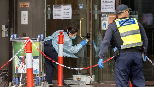 A cleaner outside the the Pullman Albert Park, which is being used to quarantine International tennis players. Picture: David Geraghty