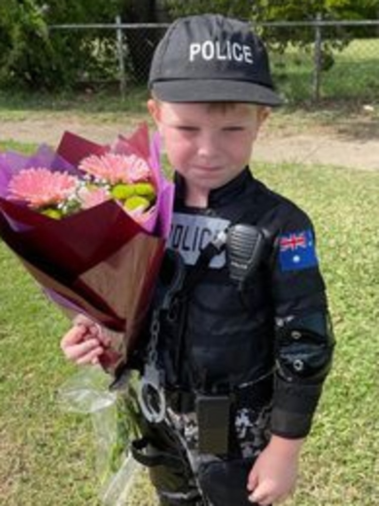 Arlo Sankey dressed as a police officer, delivering flowers to the Chinchilla station.