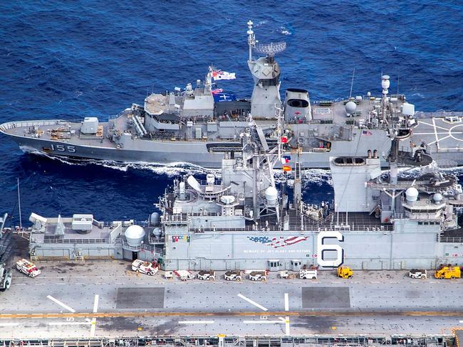 The HMAS Ballarat (back) and USS America conduct a replenishment at sea off the coat of Queensland, during Exercise Talisman Sabre 2021. Picture: LSIS Ernesto Sanchez