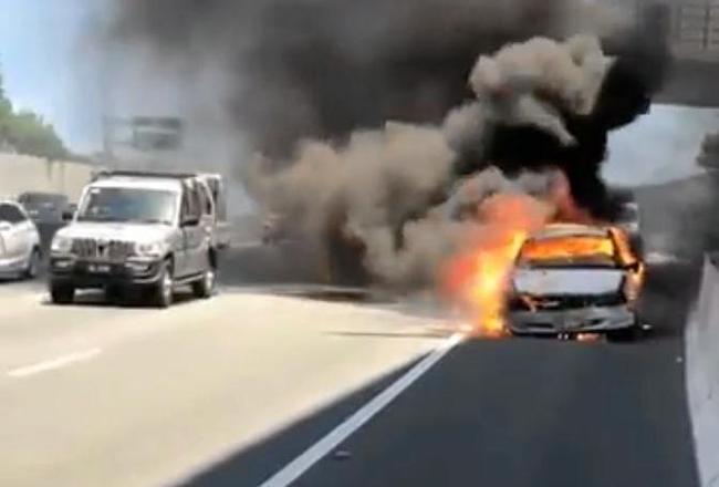 A  car was engulfed in flames after it overheated at Banora Point. Picture: Rick Koenig