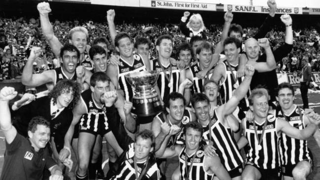 Port Adelaide players celebrate after winning the 1990 SANFL premiership.