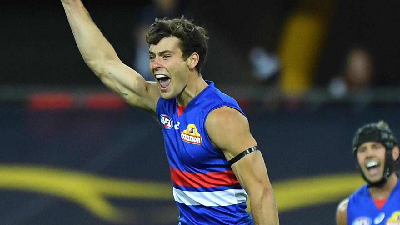 GOLD COAST, AUSTRALIA - AUGUST 28: Josh Dunkley of the Bulldogs celebrates kicking a goal during the round 14 AFL match between the Western Bulldogs and the Geelong Cats at Metricon Stadium on August 28, 2020 in Gold Coast, Australia. (Photo by Matt Roberts/AFL Photos/via Getty Images)