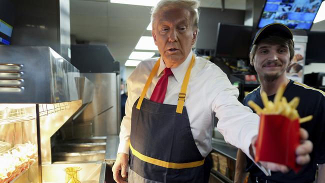 Former President Donald Trump was intent to do it his way, even handing off an order of fries during a visit to a McDonald's. Picture: Doug Mills/The New York Times via AP, Pool