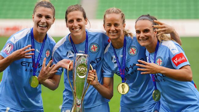 Aivi Luik, Steph Catley, Rebekah Stott and Ellie Carpenter celebrate with the trophy after winning the W-League Grand Final match in March last year.