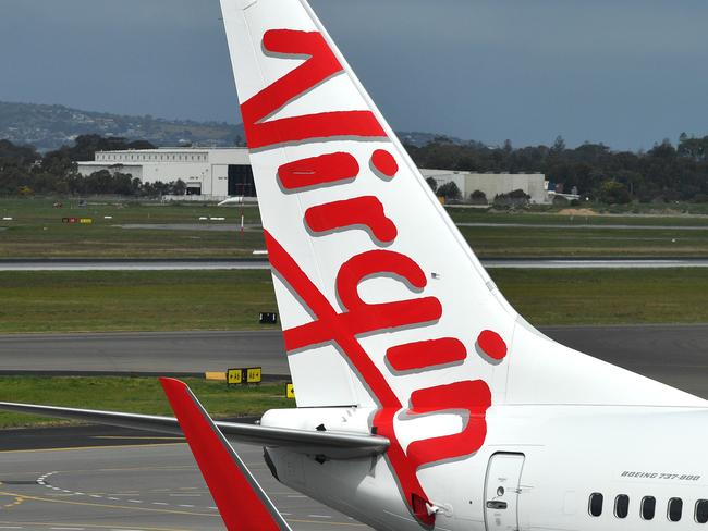 A Boeing 737-800 is seen at the Virgin Australia Airlines terminal at Adelaide Airport in Adelaide, Wednesday, August 28, 2019. Virgin Australia has reported a full-year loss of $349.1 million, saying it will cut 750 corporate and head office positions. (AAP Image/David Mariuz) NO ARCHIVING