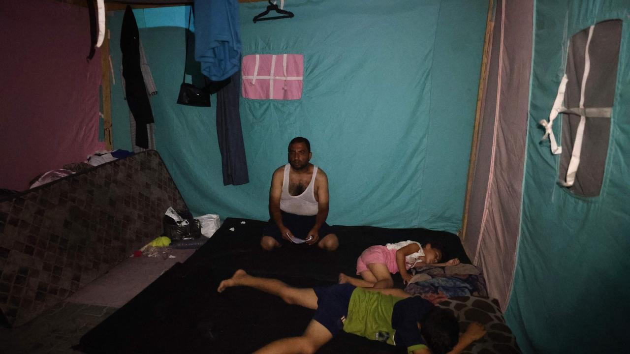 A displaced Palestinian family rests in a tent at al-Bureij refugee camp in the central Gaza. Picture: AFP