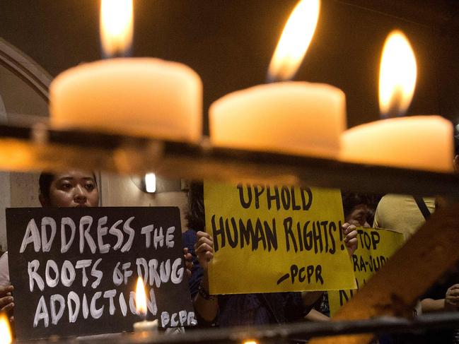 Human rights advocates hold placards condemning extra judicial killing in Manila. Picture: AFP