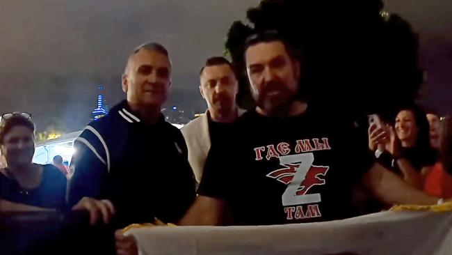 An image taken from video that purports to show Srdjan Djokovic (L), Novak Djokovic's father, with supporters of Vladimir Putin outside of Rod Laver arena on Wednesday night, 25th of January, 2023.