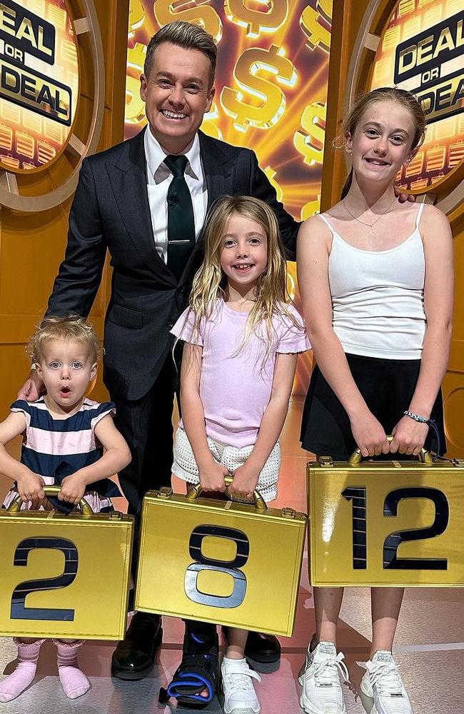 Grant Denyer and his three daughters - Sailor, Scout and Sunday - on set of Deal or No Deal. Picture: Instagram