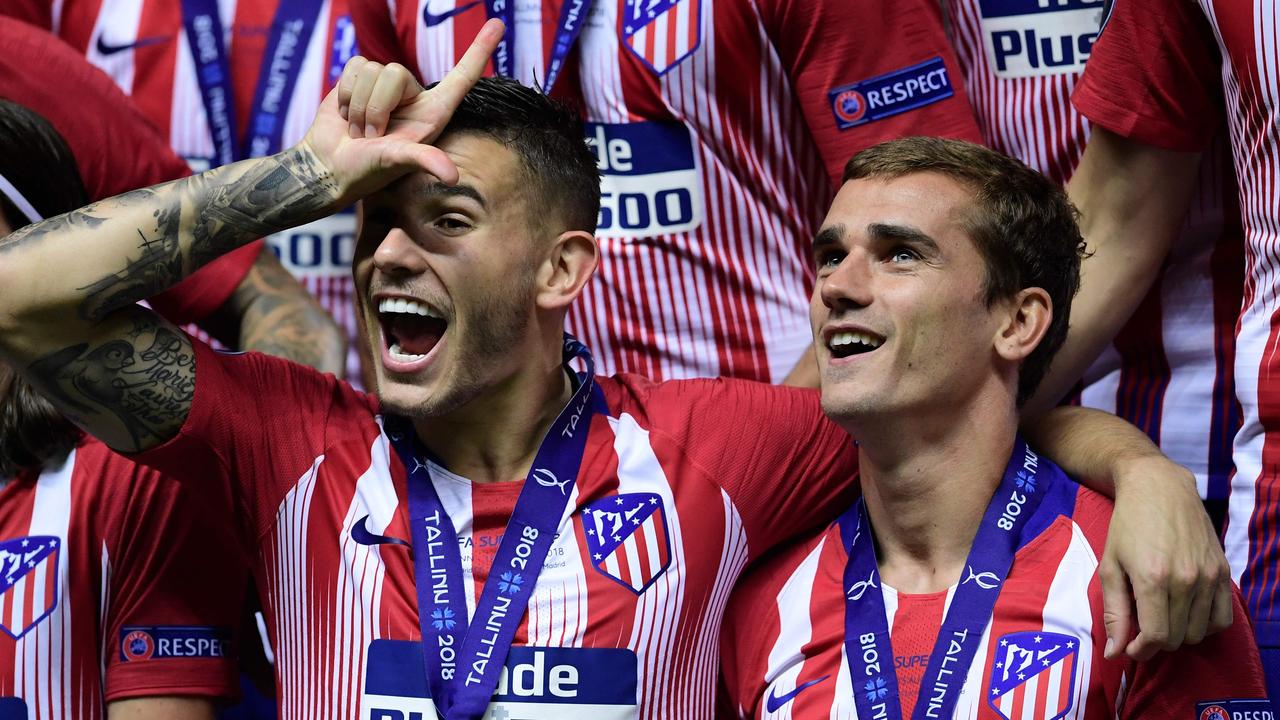 Atletico Madrid's Antoine Griezmann (R) and Lucas Hernandez celebrate at the end of the UEFA Super Cup.