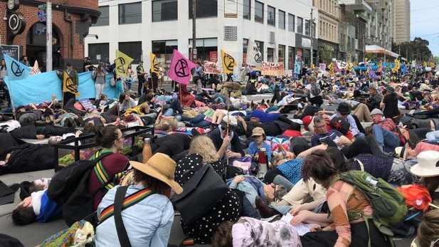 Extinction Rebellion protesters at a "drown in" on Brunswick St. Picture: Angelica Snowden