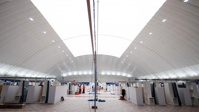 Workers are seen in the New York-Presbyterian's Northern Manhattan Field Hospital, which is under construction inside Columbia University's Baker Field Athletic Complex.