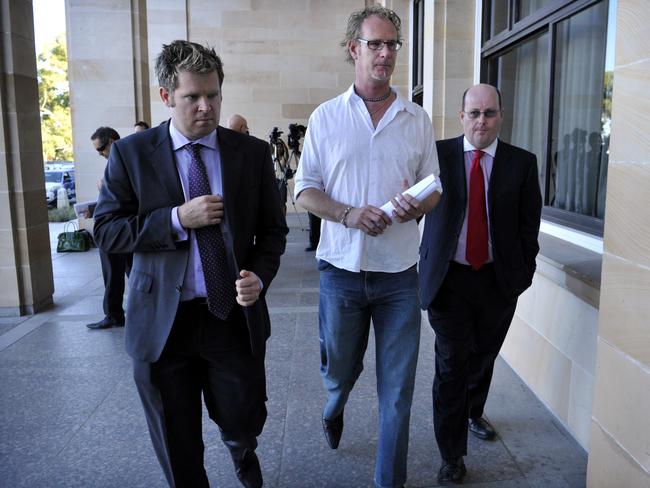 Andrew Mallard, centre, with his lawyers after being award a payout over his wrongful conviction.