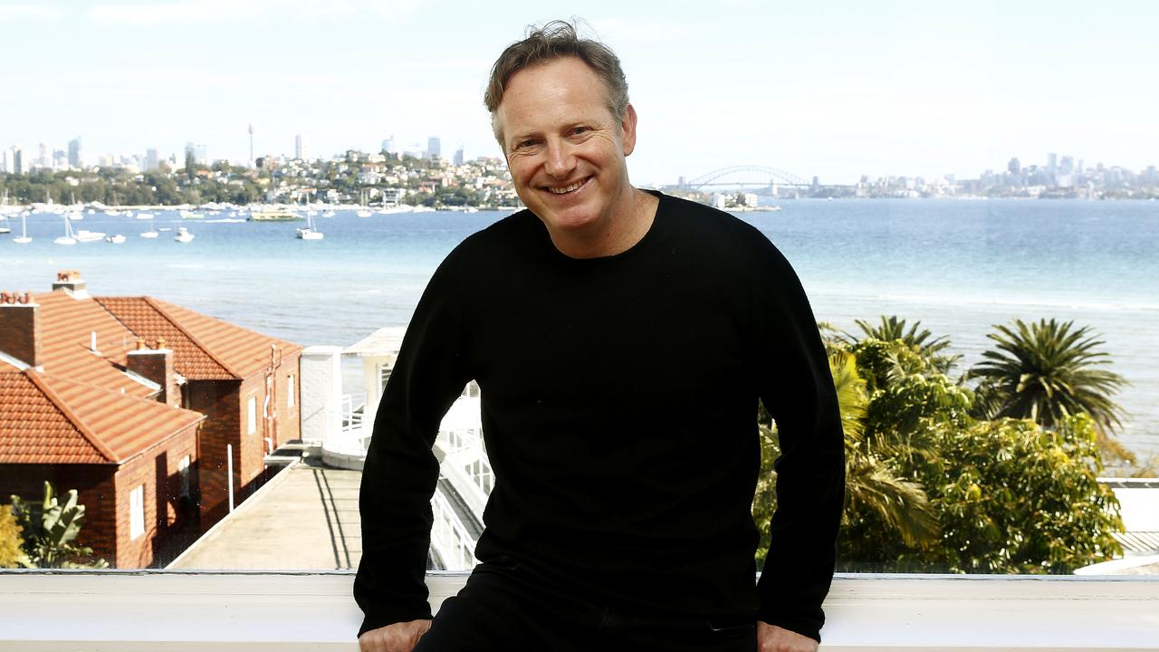 Conductor Alexander Briger, with the impressive view from the Rose Bay property, in 2019. Picture: John Appleyard