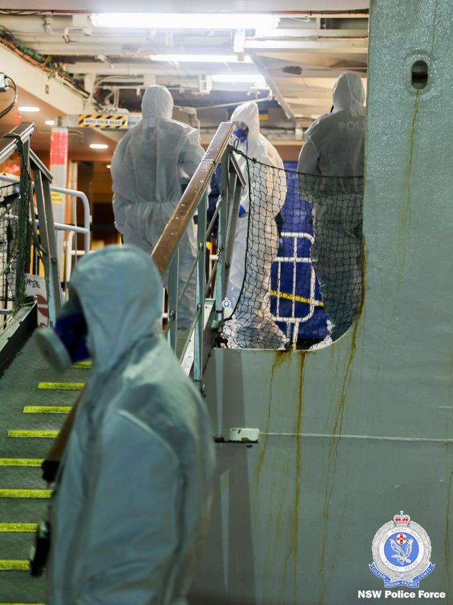 Police officers about to raid the coronavirus-stricken Ruby Princess.