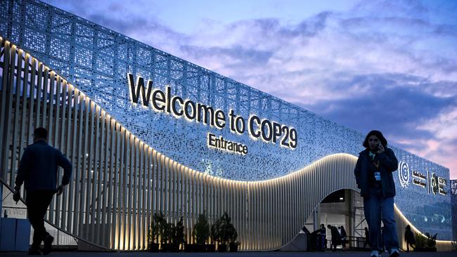 Pedestrians walk in front of the venue for COP 29 Summit in Baku. Picture: AFP