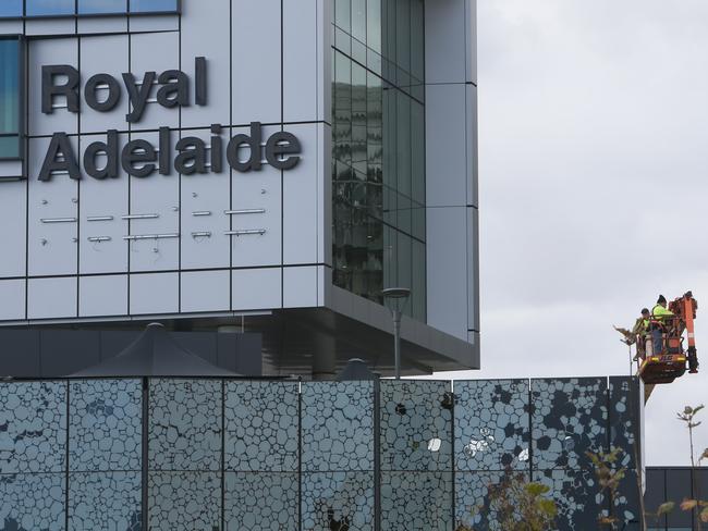 RAH - The New Royal Adelaide Hospital Signage being put up again after being taken down earlier in the day for an unknown reason. Cladding? (AAP/Emma Brasier)