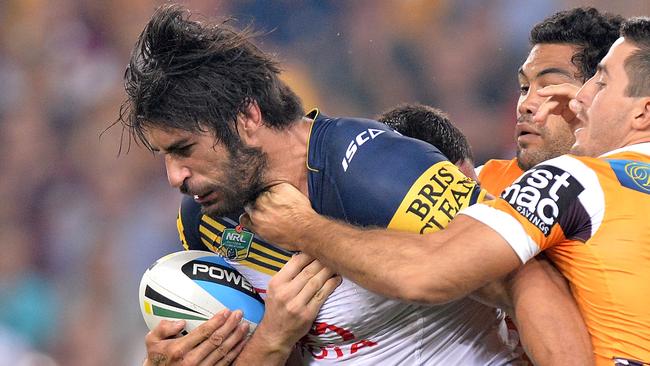 James Tamou attempts to break free from the Broncos defence.