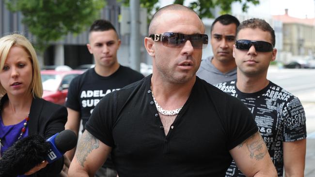 Vince Focarelli with stepson Giovanni Focarelli (right), flanked by reporters and supporters outside the Adelaide Magistrates Court in 2012. Picture: Greg Higgs