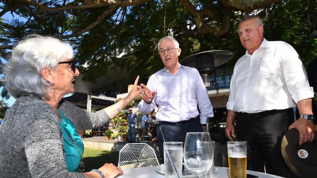 Local resident Toni Lea (left) berates Malcolm Turnbull and LNP candidate for Longman Trevor Ruthenberg at the Sandstone Point Hotel. Picture: AAP.