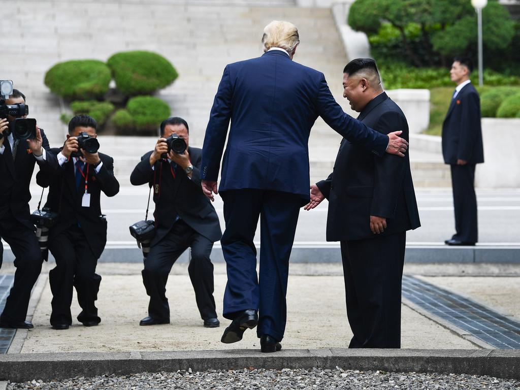 Donald Trump steps into the northern side of the Military Demarcation Line that divides North and South Korea, as North Korea's leader Kim Jong-un looks on, in the Joint Security Area (JSA) of Panmunjom in the Demilitarised zone (DMZ). Picture: AFP