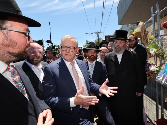 Prime Minister Anthony Albanese visits the fire damaged Adass Israel Synagogue in Ripponlea. The PM is treated by Jewish community leaders and walks to the temporary fence covered in flowers. Picture: David Caird