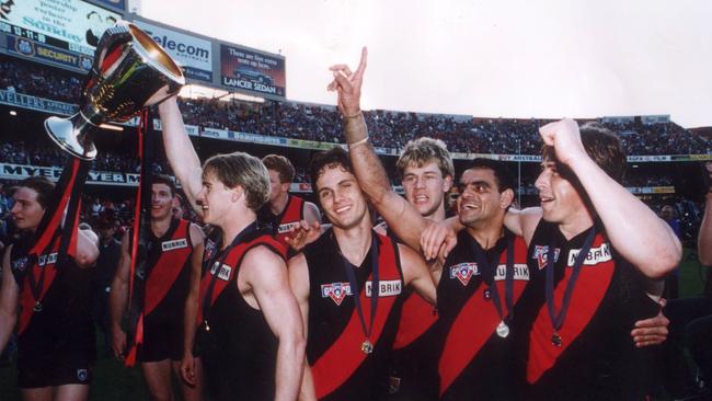 Gavin Wanganeen, Mark Harvey, Michael Long and Mark Thompson with the premiership cup. 1993 Grand Final. Essendon v Carlton. MCG.