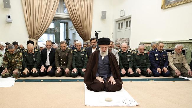 Iran's Supreme Leader Ayatollah Ali Khamenei leading prayers with a group commanders of the Iranian armed forces in Tehran. Picture: AFP Photo/Ho/Khamenei.IR