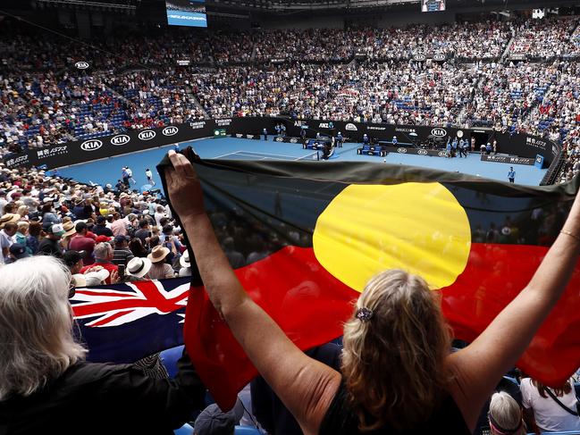 Spectators hold up the Australian and Indigenous flags at last year’s Australian Open tennis tournament. Picture: Getty Images