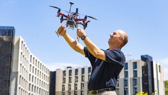 Wing man: Monash University’s Professor Jeff Walker with an autonomous drone on the uni’s Clayton campus. Picture: Dannika Bonser