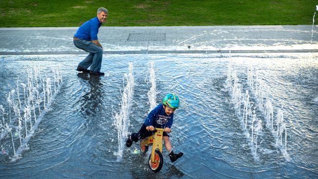 Bennett Fitzgerrald, 4, and his Dad Luke enjoy the Victoria Square fountains. Picture: Mike Burton.