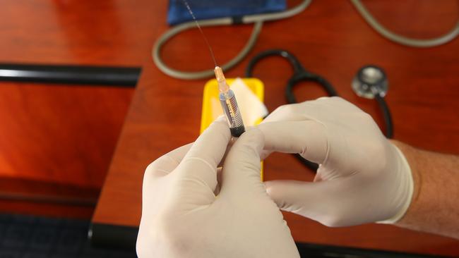 Testing a measles vaccination needle in Sydney.