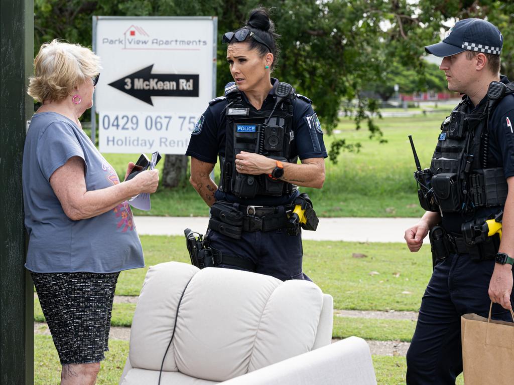 Police officers Danelle O'Rourke and Mitchell Hodkinson hand out what to do packs to affected residents. Photo Paul Beutel