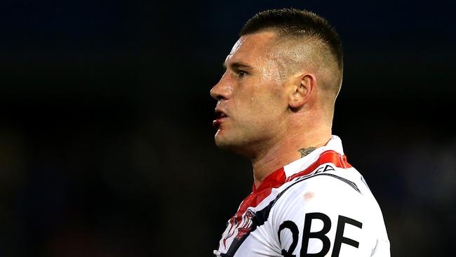 Shaun Kenny-Dowall of the Roosters looks on.