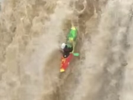 Moment 'mad man' kayaks off waterfall