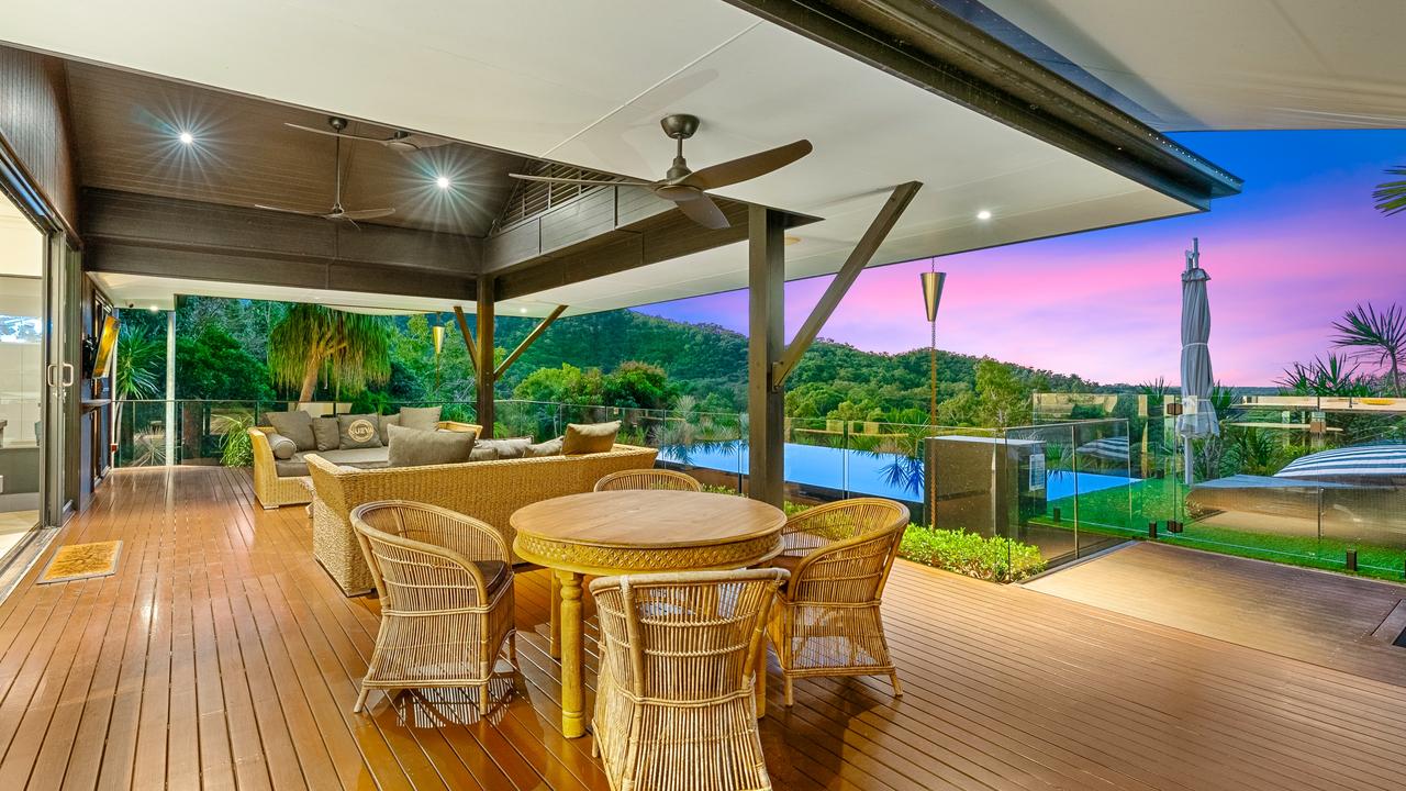 The retreat, sitting at the highest point of the holding surrounded by tropical rainforest, captures views from the entertaining deck, which has a blue-tiled wet edge pool and pizza oven. Picture: Supplied