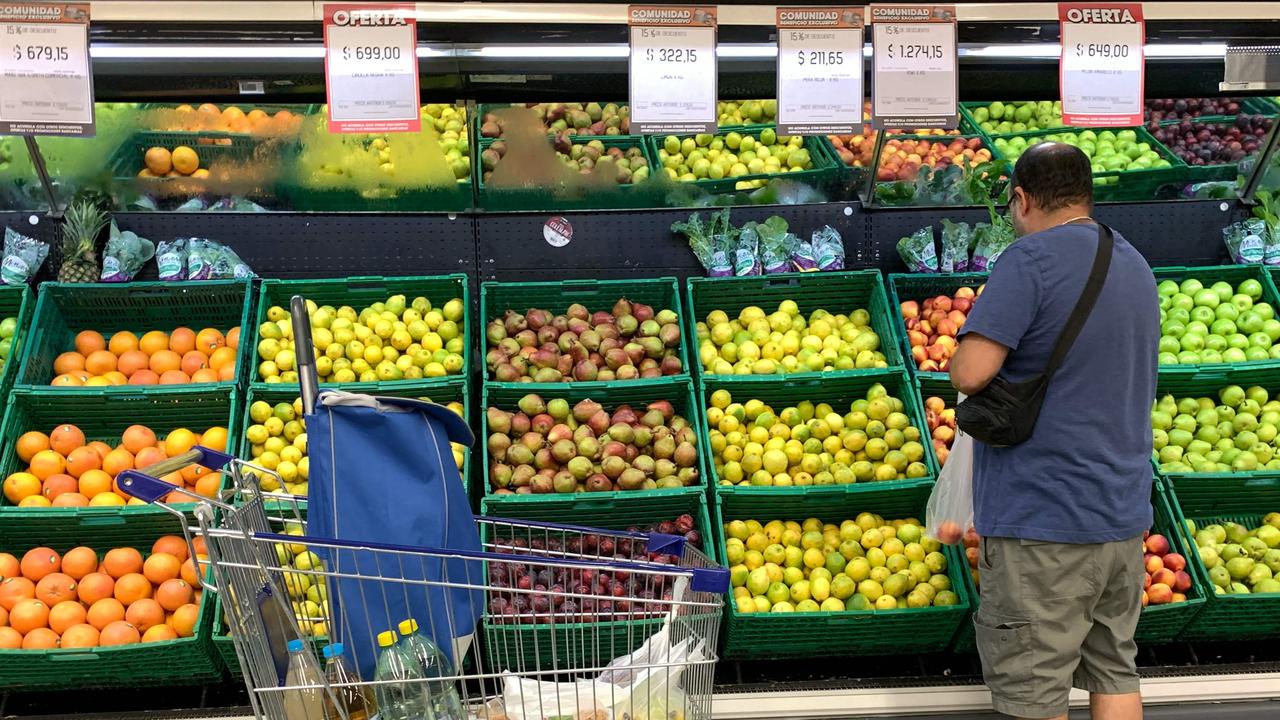 A man buy fruit in a supermarket in Buenos Aires on March 15, 2023. Inflation in Argentina came in at 102.5 per cent in the 12 months to February, exceeding the symbolic triple-digit mark and reaching a new 32-year high. Picture: AFP