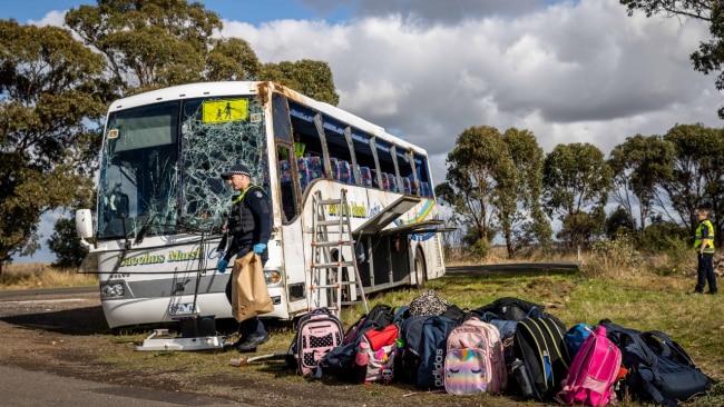 Crash scene investigators continue their investigation while emergency services pick up school bags from the scene. Source: News Corp.