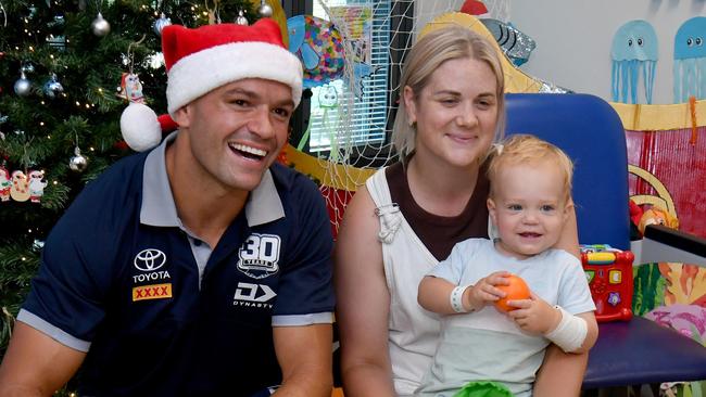 Cowboys Braidon Burns paid a surprise visit to patients, including Christie Ingrey with Leo, 14 months, from Mackay, at the Childrens' Ward at the Townsville University Hospital. Picture: Evan Morgan