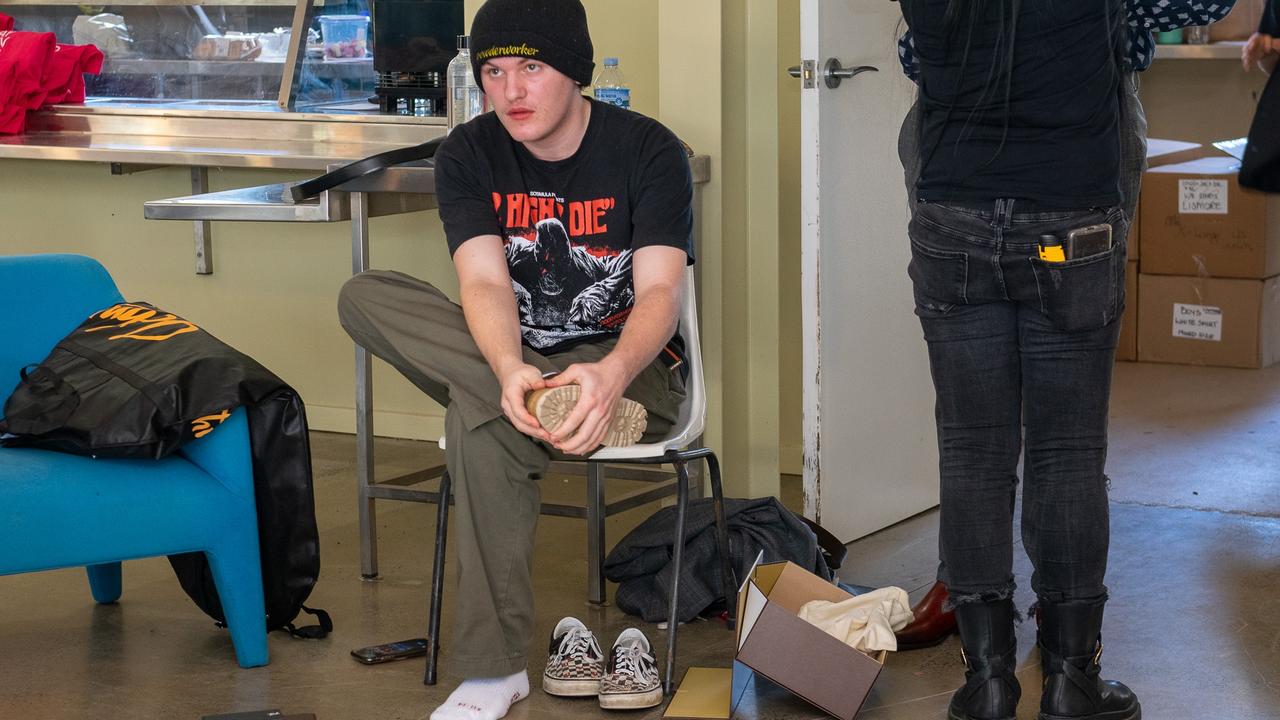 HSC student Luke Walker trying on some boots at the Lismore Showgrounds.