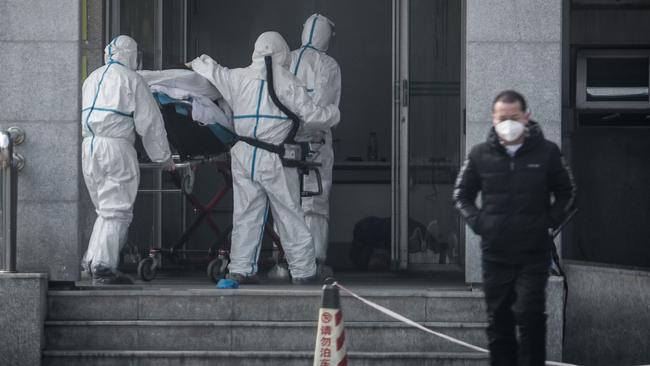 Medical staff transfer patients to Jin Yintan hospital in Wuhan, China, after the confirmation of a fourth death due to a new pneumonia-like virus. Picture: AFP