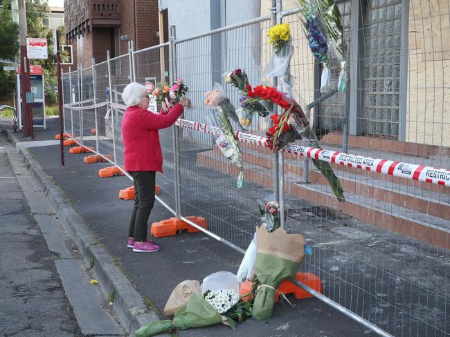 A woman leaves flowers at the Adass Israel Synagogue on Sunday morning. Picture: David Crosling