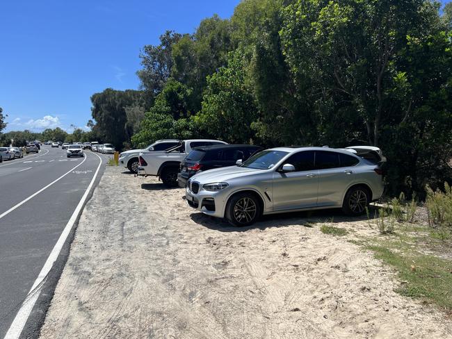 Linda Smith's car and others parked on Seaworld Drive on The Spit on February 26. Ms Smith was fined $179 for not parking parallel to the road.