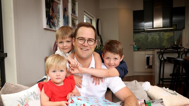 Dad Joseph Du Rieu with Christmas presents from his kids Reuben, 4, Rachel, 2, and Dominic, 6. Picture: David Caird