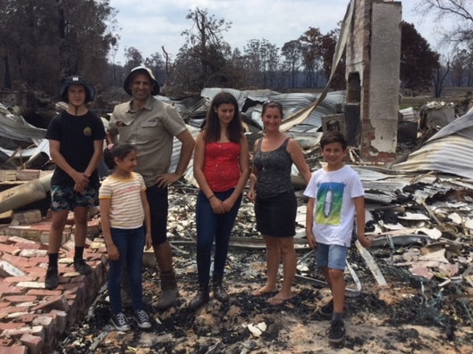 The Zagami family survey the damage on their Wairewa farm after the Black Summer bushfires.