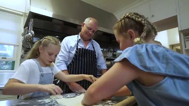 Mr Morrison helps his daugthers in the kitchen. Picture: Twitter