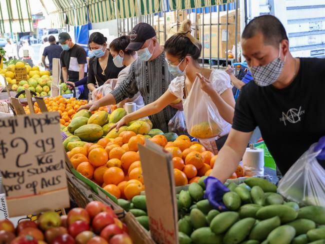 22/08/2021 Cabramatta during lockdown, shoppers wearing masks buying fruit at a Dutton Lane grocery store.  Stephen Cooper/The Australian